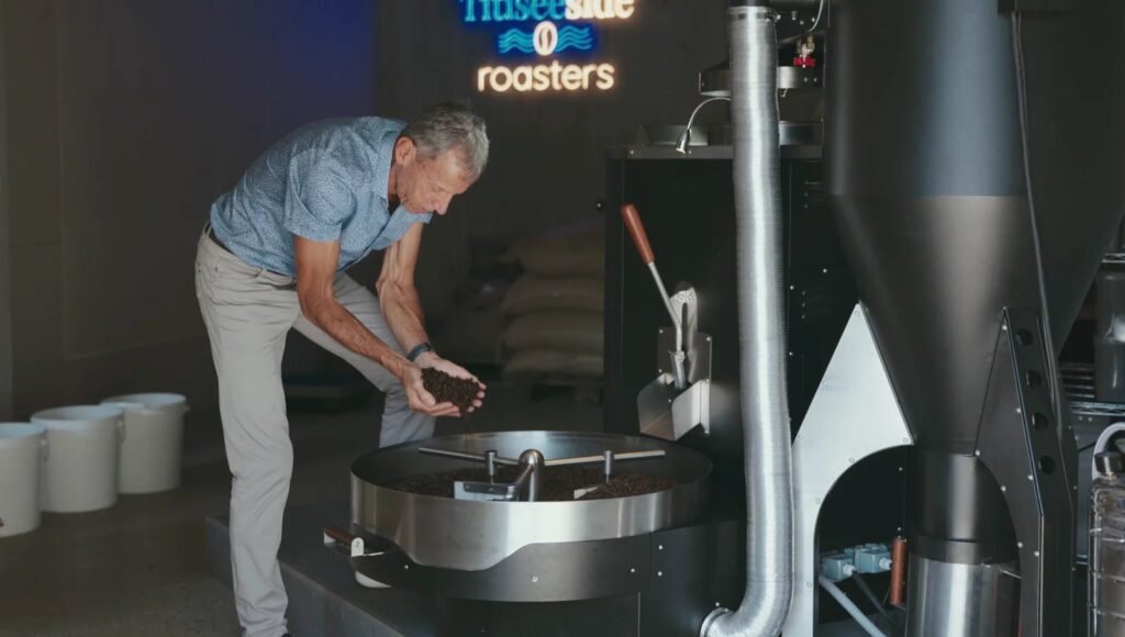 Röster prüft die Bohnen an der Röstmaschine – Videostill, Seehotel Wiesler